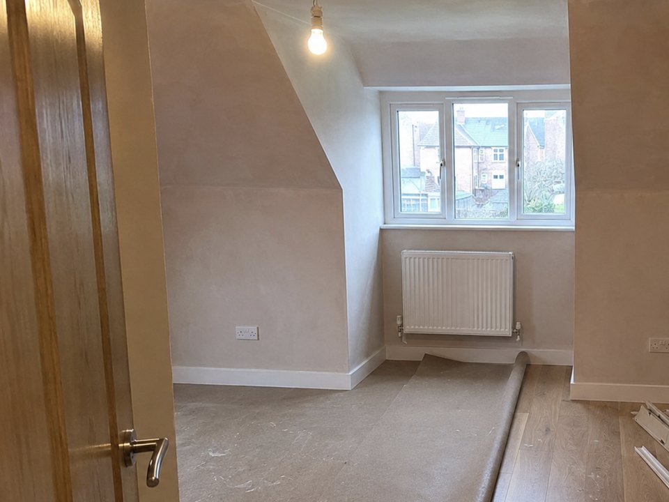 Loft room plastered out with a dormer window and the floor going down