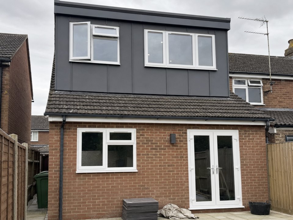 Rear extension in brick with a clad loft dormer above